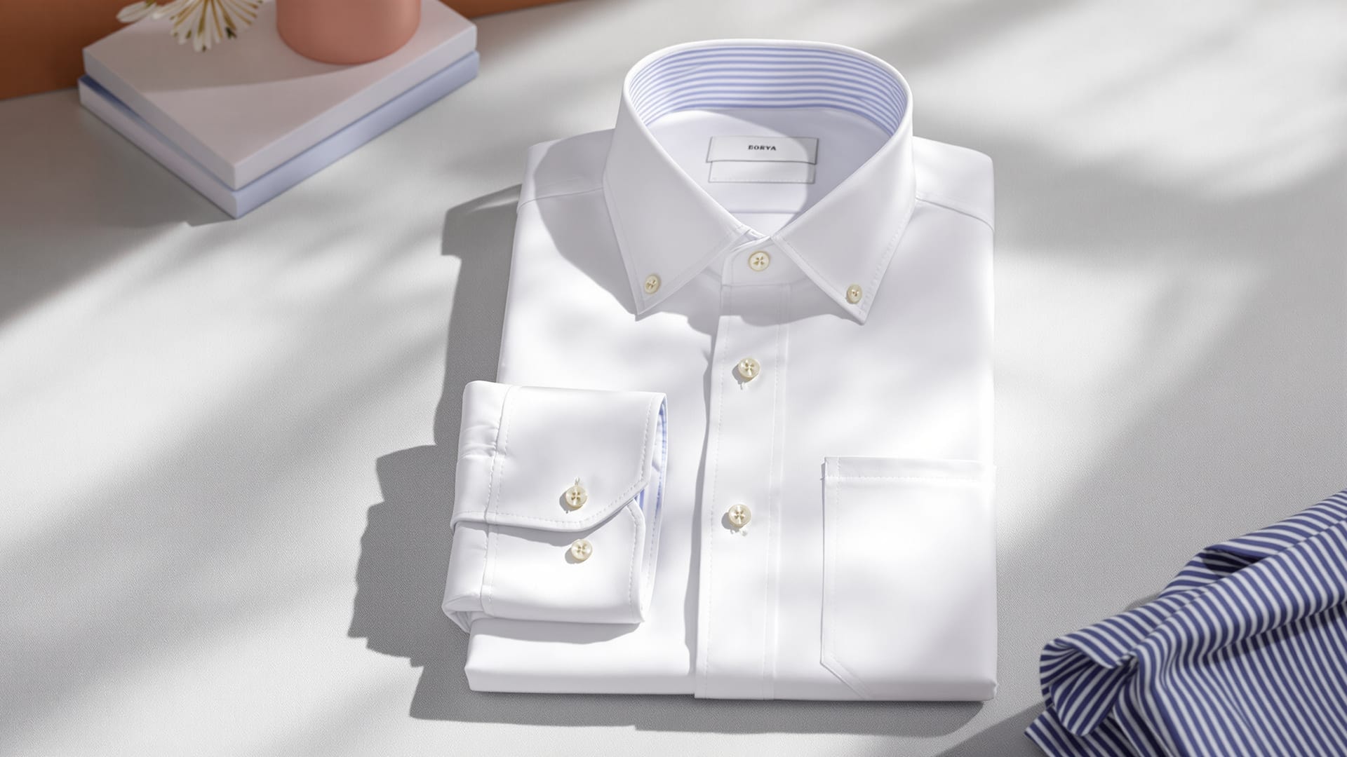 A white two-fold cotton dress shirt laid flat with its double cuff turned back